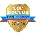 Gold shield badge labeled "Top Doctor" from findatopdoc.com for 2024, featuring a logo with a running figure.